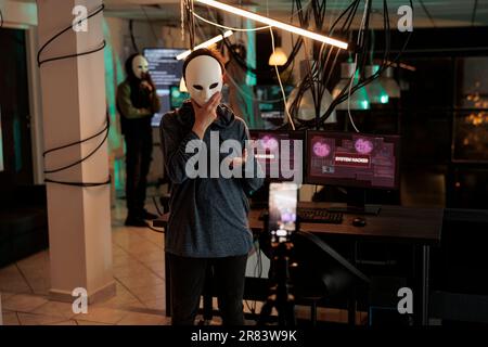 Cybercrime, thief recording video, asking money for ransom, anonymous threatening on smartphone camera, hacker stealing banking information. Online scam, criminal calling victim Stock Photo
