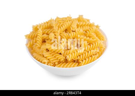 Fusilli in bowl and isolated on white background. Raw pasta spiral shape, ingredient for cook, traditonal italian cuisine. Stock Photo