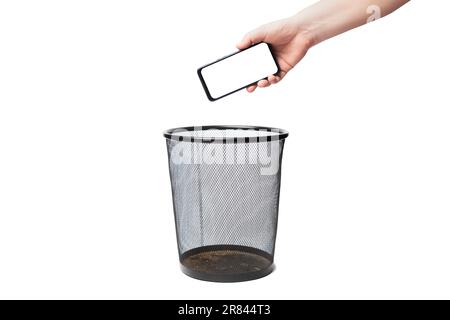 Man dump a blank screen smartphone in a trash bin Stock Photo