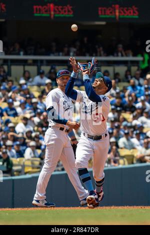 Los Angeles Dodgers shortstop Mookie Betts, top, throws out Chicago Cubs'  Patrick Wisdom at first after forcing out Cody Bellinger at second during  the eighth inning of a baseball game in Chicago