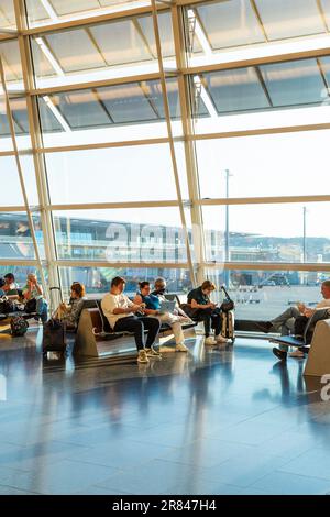 People waiting for flights at Zurich Airport, Switzerland Stock Photo