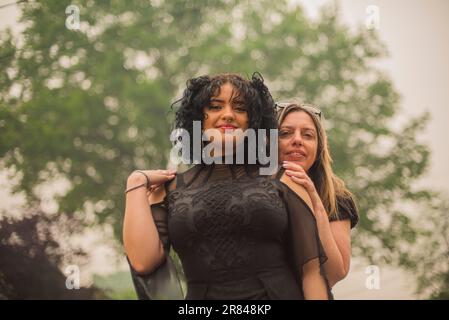 Mother hugs daughter who is Dressed for the senior Prom Stock Photo