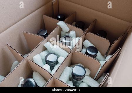 Filling the carton - packing for shipping the glass Stock Photo