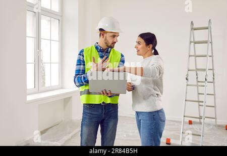 Female homeowner indicates on her laptop her preferences for repairing her new apartment. Stock Photo