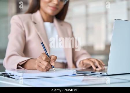 Close up view of professional business woman working writing notes in notebook. Stock Photo