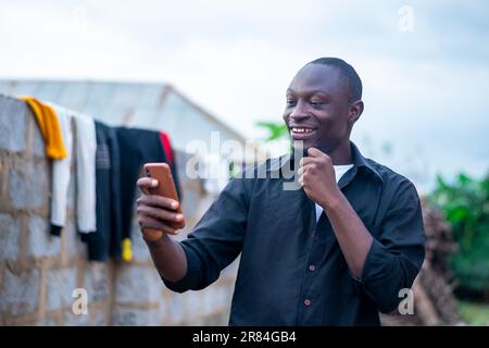 excited black man using his mobile phone. making use of wireless technology Stock Photo