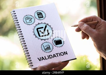 Hand drawing validation concept on a notepad Stock Photo