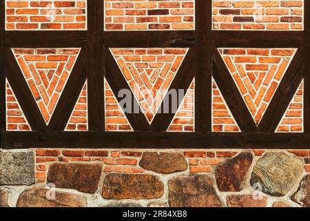 Half-timbered old house wall, brick wall pattern with joist timber framework. Detail from town of Halmstad in Sweden. Scandinavian style architecture Stock Photo
