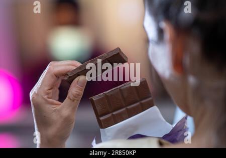 Beautiful young couple eating chocolate at home Stock Photo - Alamy