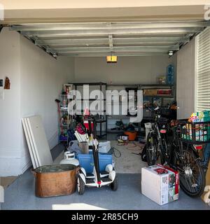 Orlando, FL USA - March 3, 2022: An unorganized garage filled with a lot of stuff in a neighborhood. Stock Photo