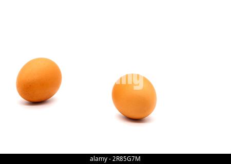 Two brown eggs from a chicken on a white background. Isolated. Photo in high quality. Stock Photo