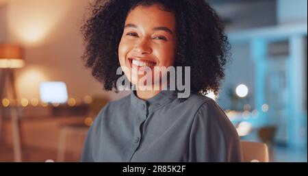 Face of happy woman in office at night working on computer at international, global or online internet company. Portrait of professional, young and Stock Photo