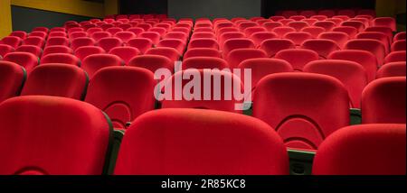 Red auditorium chairs. Empty movie theater seats Stock Photo
