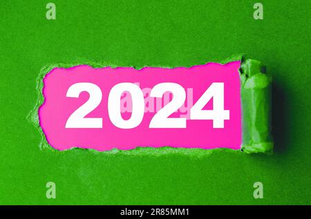 Year 2024 lettering on torn paper. New year calendar Stock Photo