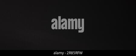 Industrial black sandpaper texture. High resolution dark embossed backdrop. Panoramic background for banner Stock Photo