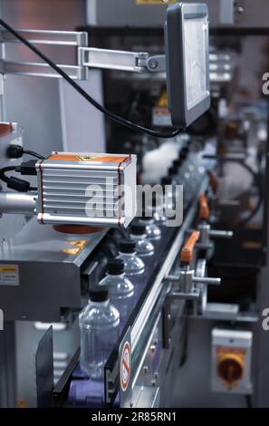 Liquid filling and bottle capping machine. Water bottling plant. Stock Photo