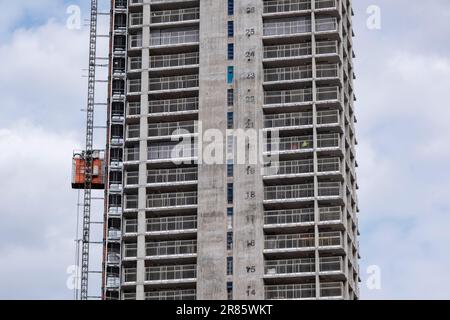 New residential apartment buildings under construction as part of development / redevelopment in the city centre as new high rise blocks rise with the floor level numbers visible on the exterior of the lift shaft on 18th May 2023 in Birmingham, United Kingdom. The city is under a long term and major redevelopment, with much of its industrial past being demolished and made into new flats for residential homes. Stock Photo