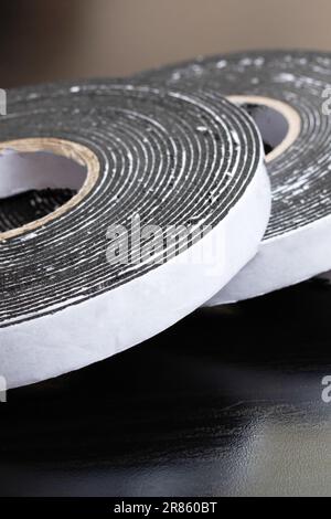 Three reels of double-sided tape on wooden table Stock Photo