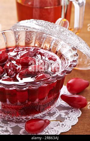 Jam with fresh fruits of cornel in glass bowl Stock Photo