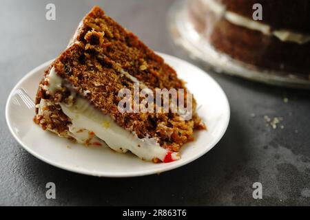 Slice of homemade carrot cake, selective focus Stock Photo