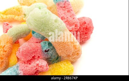 Freeze Dried Bicolored Candy Sour Worms Isolated on a White Background Stock Photo