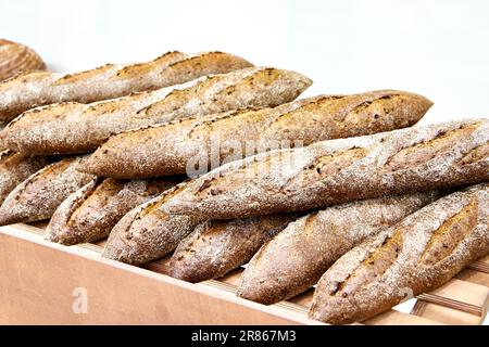 Fresh bread baguette on shelves in a bakery Stock Photo