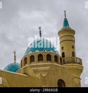 An image that captures domes and a minaret of the  Ash-Shaliheen Mosque in the Brunei capital city of Bandar Seri Begawan Stock Photo