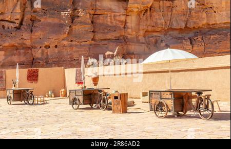 Al Ula old arabic town souk market street with wheeled trading stalls and umbrellas, Medina province, Saudi Arabia Stock Photo