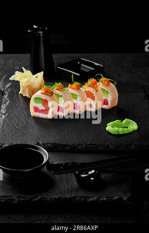 Rolls in mamenori with tuna, salmon, avocado, cream cheese and tobiko Stock Photo