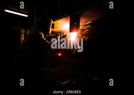 Welder at work in a copper mine Stock Photo