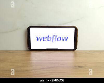 Konskie, Poland - June 17, 2023: Webflow website development tool logo displayed on mobile phone screen Stock Photo