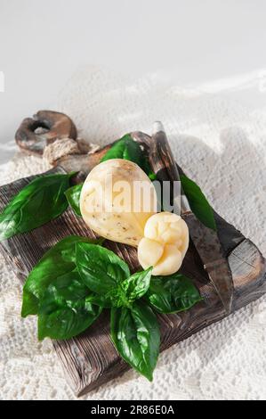 scamorza, Pasta Filata, Italian cheeses collection, smoked scamorza pear shaped cheese from small cheese farm in South Italy made from cow milk. Stock Photo
