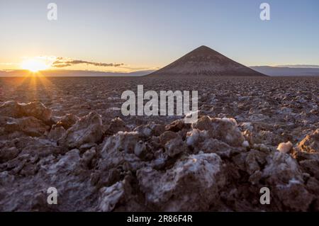 Perfectly shaped Cono de Arita in the Salar de Arizaro in the morning - Exploring the Argentinian highlands called Puna while traveling South America Stock Photo