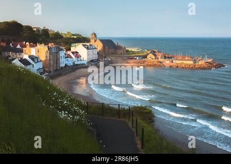 Scenic golden hour sunset view of harbour and beach at the coastal seaside fishing village of Kinghorn, Fife, Scotland, UK on a summer evening. Stock Photo