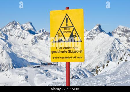 End of a ski area warning sign on ski slope, in German, at Ischgl ski resort, on the border of Austria and Switzerland. Stock Photo