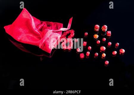 Red beads and a red bag on a black background Stock Photo
