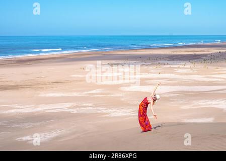 Relaxed and happy woman enjoying summer sunny day at the beach. Summer and travel concept. Stock Photo