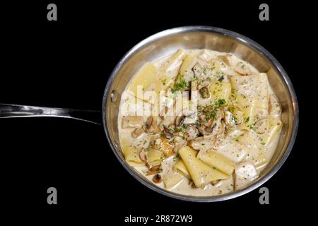 traditional italian creamy wild mushroom pasta with truffle, ceps and porchini, black background Stock Photo