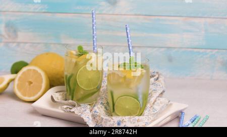 Summer citrus fruits drink on wooden background. Detox citrus infused flavored water. Refreshing summer homemade cocktail with lemon. Fresh lemon and Stock Photo