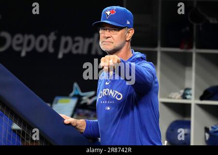 Toronto Blue Jays manager John Schneider (L) and bench coach Don