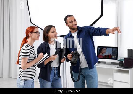 Young professional photographers working in modern photo studio Stock Photo