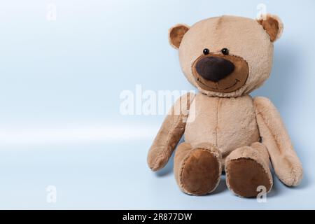 Cute teddy bear on light background, space for text Stock Photo