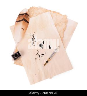Parchment with stains of ink, feather pen and inkwell on white background, top view Stock Photo