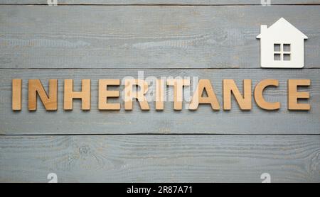 Word Inheritance made with letters and house model on wooden background ...