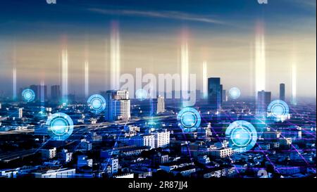 Smart city and wireless communication network over the cityscape at night time, communication network technology concept. Stock Photo