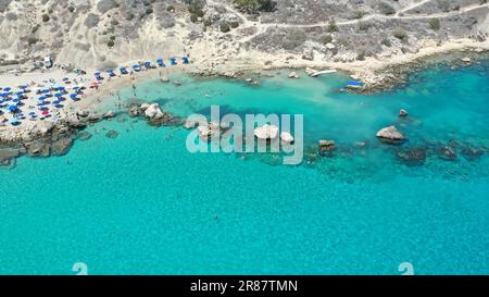 Aerial view of a crowded Konnos beach with tourists enjoying summer ...