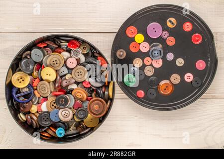 Many buttons in a plastic container on a wooden table, macro, top view Stock  Photo - Alamy