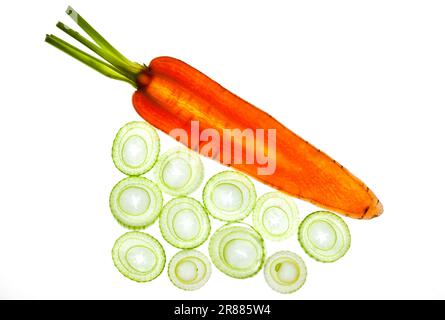 Carrot and leek, sliced and set against a white background Stock Photo