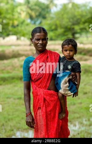A village woman holding her daughter on her hip, Tamil Nadu, South India, India, Asia Stock Photo