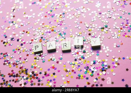 party woed on a multicolor sparkles purple pink background Stock Photo